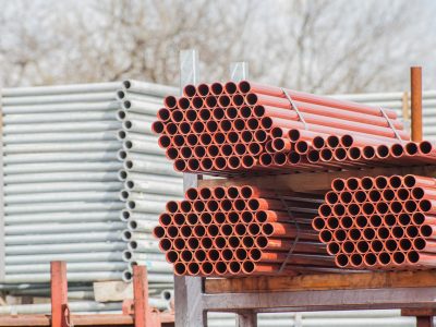 Stack of steel pipes for scaffolding in warehouse