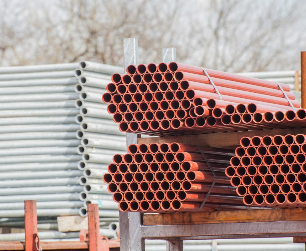Stack of steel pipes for scaffolding in warehouse